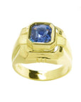 Men's 18K yellow gold solitaire ring with a vivid blue octagonal sapphire.