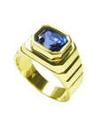 Men's 18k yellow gold ring with an octagonal blue sapphire, bezel set in an east-west orientation.