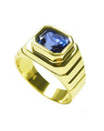 Men's 18k yellow gold ring with an octagonal blue sapphire, bezel set in an east-west orientation.