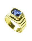 Men's 18k yellow gold ring with an octagonal blue sapphire, bezel set in an east-west orientation.