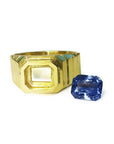 18k yellow gold men's ring setting with an octagonal bezel next to a loose blue sapphire.