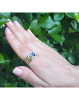 Men's 18k yellow gold ring with a vibrant blue octagonal sapphire, bezel set east-west.