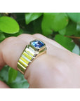 Men's 18k yellow gold ring with a bezel-set, octagonal blue sapphire.