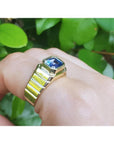 Men's 18k yellow gold ring with a bezel-set, octagonal blue sapphire.