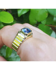 Men's 18k yellow gold ring with a bezel-set, octagonal blue sapphire.
