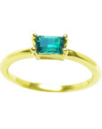 This minimalist solitaire emerald ring shows the topside profile.