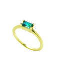This 14k minimalist solitaire emerald ring is displaying the top and side profile.