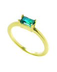 This 14k minimalist solitaire emerald ring is displaying the top and side profile.