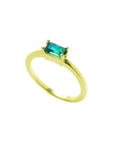 Minimalist 14K yellow gold ring with an east-west prong-set rectangular emerald.