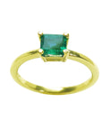 A minimalist emerald solitaire ring representing May's birthstone jewelry in 14k yellow gold.