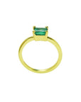 Minimalist 14K yellow gold solitaire ring with a rectangular green emerald.