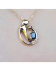 14K yellow gold mother and child slider pendant necklace with a deep blue sapphire.