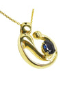Right side top view of a mother and child sapphire necklace slider pendant crafted in 14k yellow gold