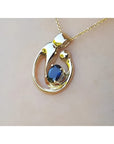 Displaying a gold pendant with a natural blue sapphire on a woman's collar neck