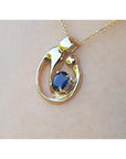 Displaying a gold pendant with a natural blue sapphire on a woman's collar neck