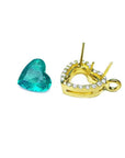 Heart-shaped Colombian emerald next to an 18K yellow gold halo diamond pendant setting.
