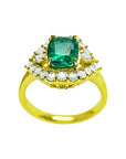 This cushion cut emerald ring displays the top stone surrounded by a halo diamond and yellow gold band perspective.