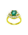 This cushion cut emerald ring displays the top stone surrounded by a halo diamond and yellow gold band perspective.