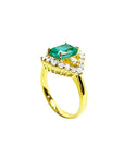 1.43 ct cushion-cut Muzo Colombian emerald ring with marquise diamond halo in 14K yellow gold.