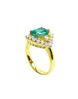 1.43 ct cushion-cut Muzo Colombian emerald ring with marquise diamond halo in 14K yellow gold.