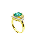 1.43 ct cushion-cut Muzo Colombian emerald ring with marquise diamond halo in 14K yellow gold.