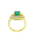 A yellow gold emerald ring displaying its lateral perspective fron the top setting. gallery and band ring.