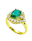 The side of this emerald ring shows the top cushion cut gemstone, the halo diamonds and band in yellow gold.