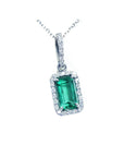 Emerald-cut gemstone pendant with diamond accents on a white background