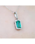 1.70 ct. Muzo Colombian emerald pendant with diamond halo on an 18K white gold chain.