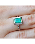 1.50 carat Muzo Colombian emerald solitaire ring in 18K white gold, rectangular cut.