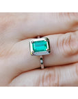 1.50 carat Muzo Colombian emerald solitaire ring in 18K white gold, rectangular cut.