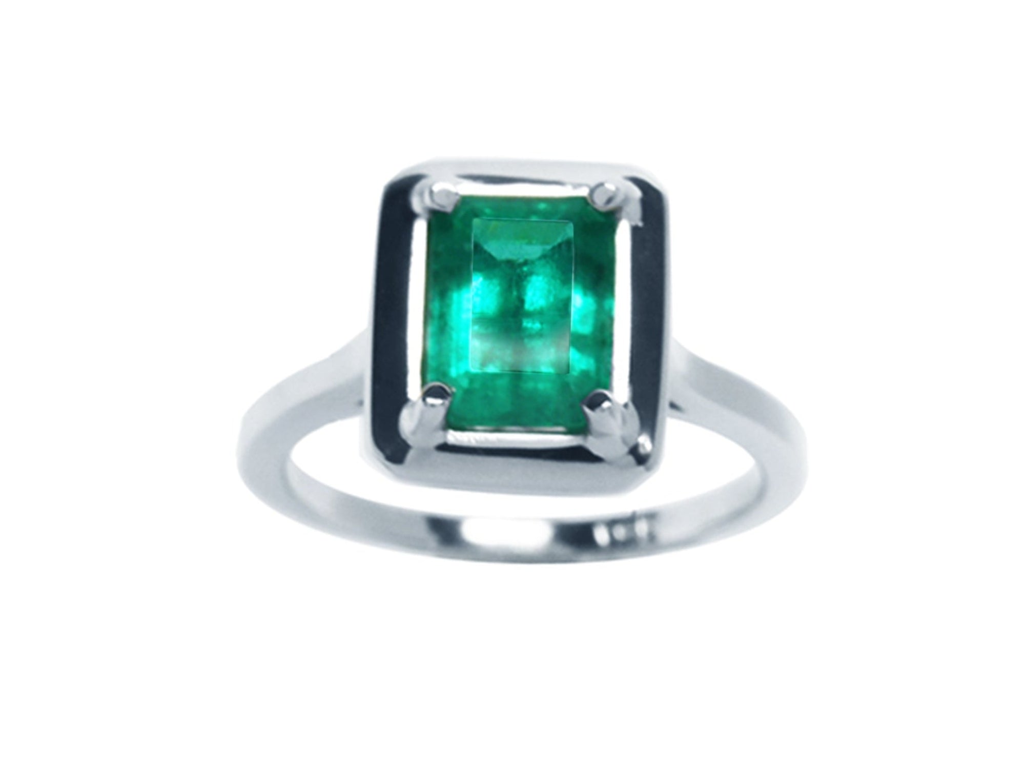 This Muzo colombian emerald solitaire ring displays its topside view of the rectangular emrald-cut prong set in 18k white gold.
