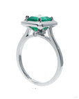A half-side of this emerald solitaire ring shows the top and band profile on a white background.