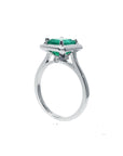 A half-side of this emerald solitaire ring shows the top and band profile on a white background.