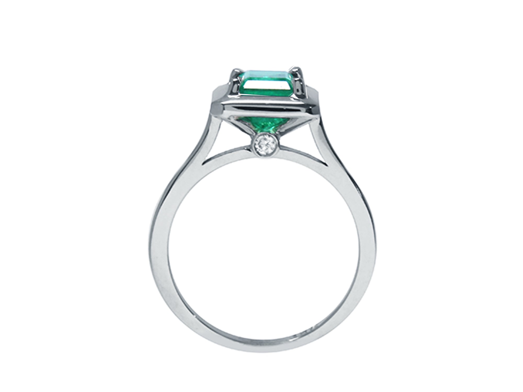 A lateral view of this solitaire emerald ring shows the setting, gallery and band, including the Centinel diamond.