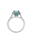 1.50 carat Muzo Colombian emerald solitaire ring in 18K white gold with a small diamond accent.