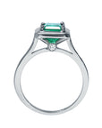 A lateral view of this solitaire emerald ring shows the setting, gallery and band, including the Centinel diamond.