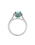 1.50 carat Muzo Colombian emerald solitaire ring in 18K white gold with a small diamond accent.