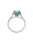 1.50 carat Muzo Colombian emerald solitaire ring in 18K white gold with a small diamond accent.