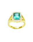 1.68 ct emerald-cut Muzo Colombian emerald ring with diamond halo and split shank in 14k yellow gold.