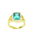This top view of a yellow gold emerald ring shows the top gemstone and a halo diamond with sides profile.