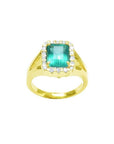 1.68 ct emerald-cut Muzo Colombian emerald ring with diamond halo and split shank in 14k yellow gold.