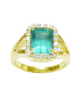 This emerald-cut Colombian emerald ring is on its front position and displays top and halo diamond view.