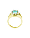 14k yellow gold ring with emerald-cut Muzo Colombian emerald, diamond halo, and split shank.