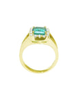 14k yellow gold ring with emerald-cut Muzo Colombian emerald, diamond halo, and split shank.