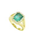 The tilted position of this halo diamond emerald ring shows the top and side profile.