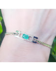 A bracelet with a natural Colombian emerald sourced from the Muzo mines very good quality, made in 14k yellow gold on a wrist.