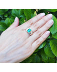 Men's 14K yellow gold ring with a rectangular bluish-green Muzo Colombian emerald.