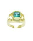 Men's 14K yellow gold ring with a rectangular bluish-green Muzo Colombian emerald.