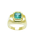 Men's 14K yellow gold ring with a rectangular bluish-green Muzo Colombian emerald.